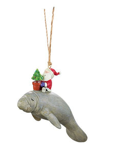 A resin Christmas ornament Santa riding a manatee