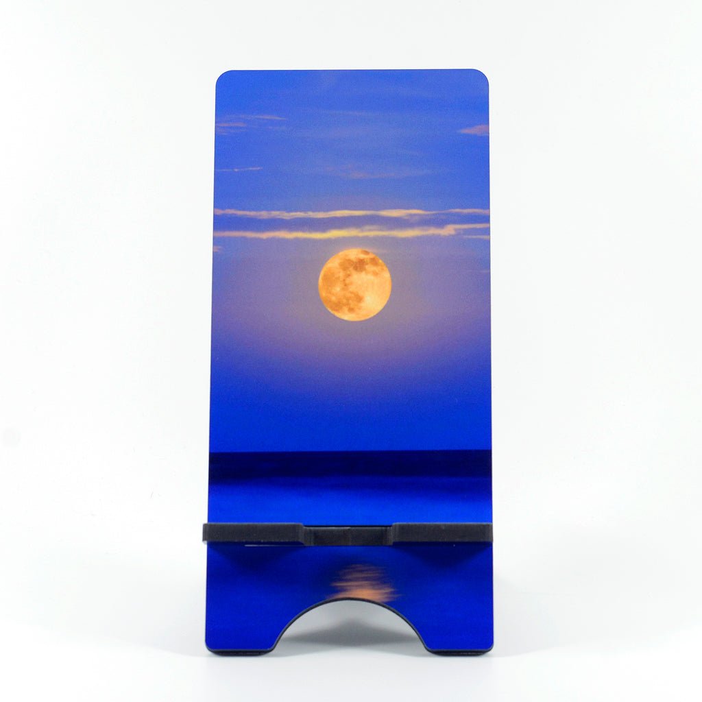 Super Moon over the ocean photograph on a phone stand