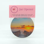 A boardwalk to the beach at sunrise photograph on a round rubber jar opener