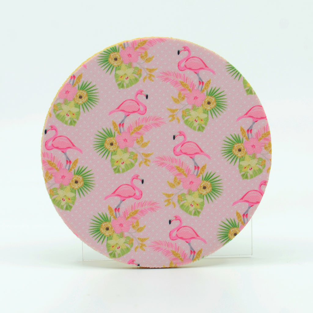 A collage of pink flamingos on a 4" round rubber coaster