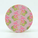 A collage of pink flamingos on a 4" round rubber coaster