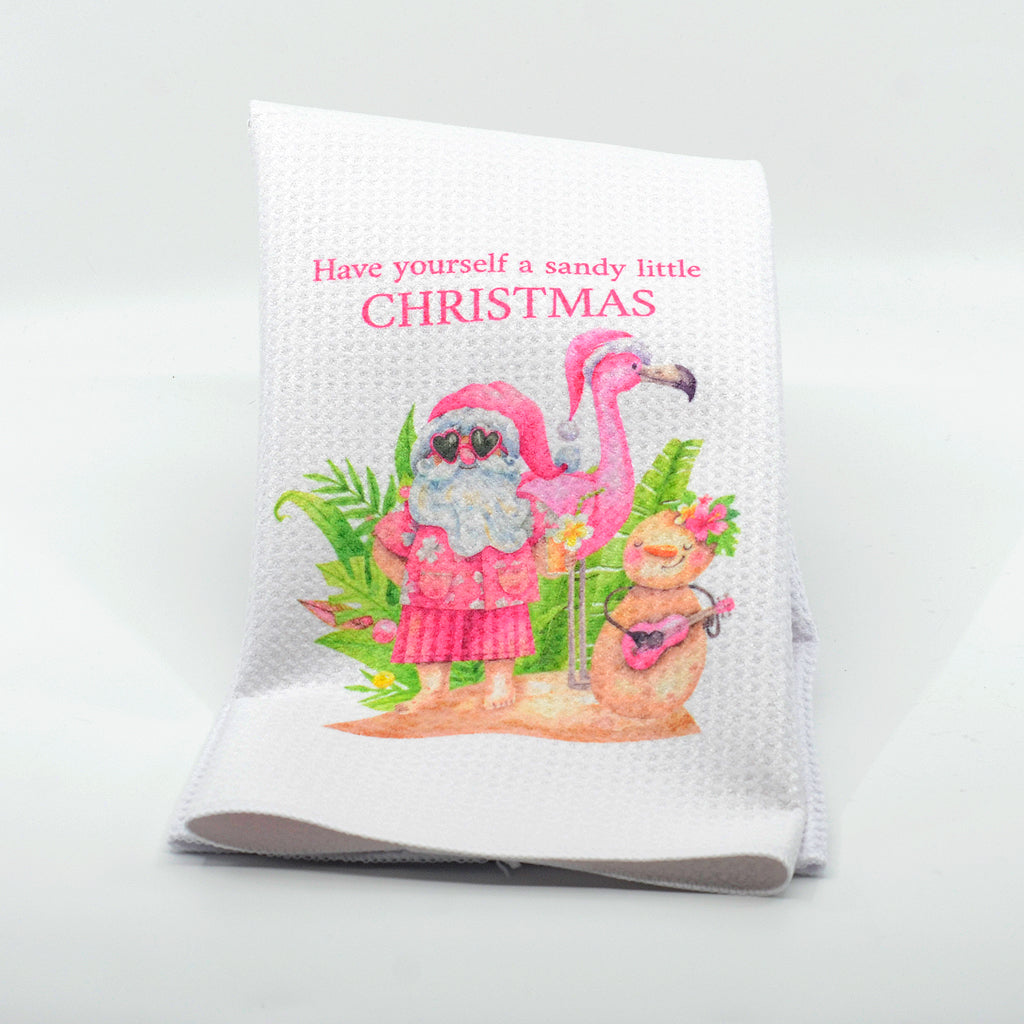 Santa and Flamingo graphics on a waffle kitchen towel