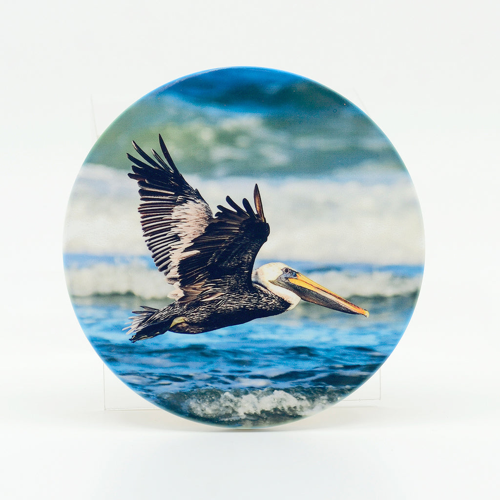 pelican flying photograph on a 4" round rubber home coasters