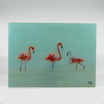 Tempered Glass Small Rectangle Cutting Board with 3 flamingos in a salt pan