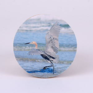 4" round rubber coaster with Reddish Egret in the ocean water