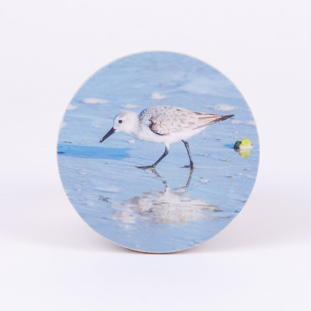 4" round rubber coaster with sandpiper on the shore
