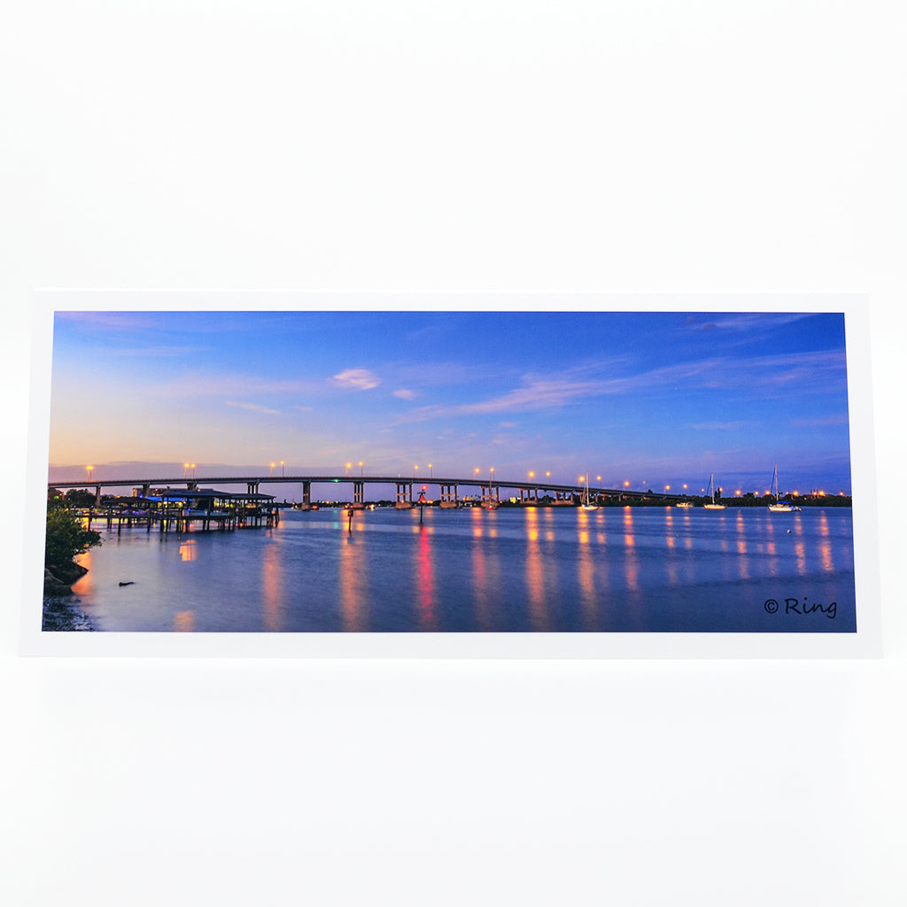 "South Bridge 2" notecard.  A panoramic view of the south bridge and sailboats at dusk in New Smyrna Beach, Florida.   This artwork is printed on an amazing quality notecard.